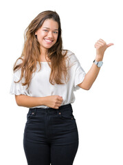 Sticker - Young beautiful brunette business woman over isolated background smiling with happy face looking and pointing to the side with thumb up.