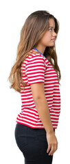 Wall Mural - Young beautiful brunette woman wearing stripes t-shirt over isolated background looking to side, relax profile pose with natural face with confident smile.