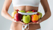 Healthy Woman Holding Fresh Fruits With Measuring Tape Around Waist. Healthy Food Nutrition, Wellness and Diet concept