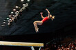 exercise on balance beam gymnastics, female gymnast perform backward somersault landing on floor