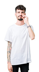 Poster - Young handsome man wearing white t-shirt over isolated background mouth and lips shut as zip with fingers. Secret and silent, taboo talking