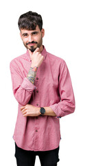 Poster - Young handsome man wearing pink shirt over isolated background looking confident at the camera with smile with crossed arms and hand raised on chin. Thinking positive.