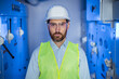 © Ivan - Portrait of serious confident young Caucasian engineer worker with beard in protective goggles in industry