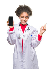 Wall Mural - Young afro american doctor woman using smartphone over isolated background very happy pointing with hand and finger to the side
