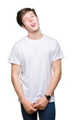 Sticker - Young handsome man wearing casual white t-shirt over isolated background sticking tongue out happy with funny expression. Emotion concept.