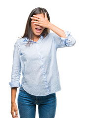 Canvas Print - Young asian business woman over isolated background peeking in shock covering face and eyes with hand, looking through fingers with embarrassed expression.