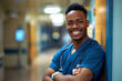 © Maria - Doctor standing in hospital. Portrait of a young African American male doctor in a hospital. Young happy doctor smiling at the camera.