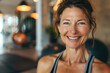 Smiling mature woman in gym. Middle aged woman in fitness center.