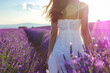 Young woman in a white dress in a lavender field at sunset.