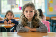 © forenna - earnest expression, a small elementary school girl sits poised at her desk in the classroom, looking directly at the camera with a sense of confidence and eagerness, symbolizing th