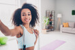 Photo of positive charming woman sportswear enjoying pilates recrding video vlog indoors house apartment room