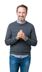 Canvas Print - Handsome middle age senior man wearing a sweater over isolated background Hands together and fingers crossed smiling relaxed and cheerful. Success and optimistic