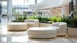 © ZinaZaval - shopping mall lounge area adorned with three round grey and beige fabric footstools, set against a backdrop of contemporary planters.
