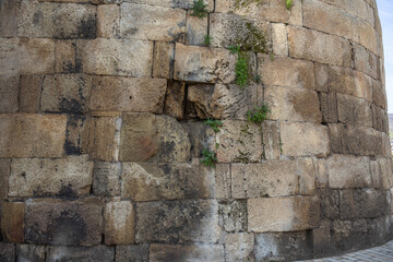 the fortress wall. A monument of ancient Persian fortification architecture. The background is made of large stone blocks. The wall is made of large stone blocks. Traces of erosion on stone