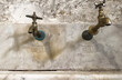 Vintage hot and cold water taps on marble surface