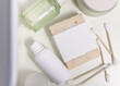 Soap bar with blank label near cosmetic products in bathroom top view, mockup