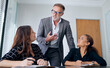 © peopleimages.com - Mature businessman, team and meeting in office with employees, leader and expertise in industry. Male boss, ideas and women together for learning, coaching and mission in corporate workplace