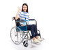 Beautiful young asian women with happy smiling sitting in a wheelchair on white background and she shows ok sign, healthcare concept, accident, insurance, life insurance, wellness, hospital.