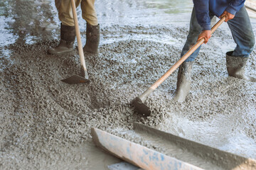 Wall Mural - Two men are working on a concrete slab