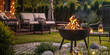 fire in a grill on the garden with deck chairs, copy space for a text banner background. Summer time concept. Barbeque party at home outdoors in the backyard