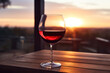 glass of red wine on a picturesque background of vineyards at sunset, close-up