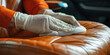 © SnowElf - Close-up Hand in rubber glove cleaning leather car seat. Car detailing worker cleaning car interior and car leather seats.