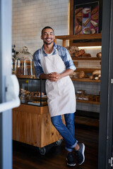 Sticker - Man, portrait and confident owner in coffee shop, small business and ready for customer service. Male person, welcome smile and waiter for hospitality in restaurant, pastry and proud of bakery store