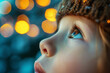 Close up focus on the eyes of a child looking up against blurred lightened background	
