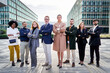 © Gigi Delgado - Large group of multiethnic business people with crossed arms standing outside financial district looking at camera with confident. Copy space.