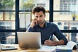 © MiraCle72 - Concerned businessman ponders over work challenges in sunlit office at dusk