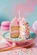 A slice of pastel pink birthday cake adorned with whipped cream on a celebratory day