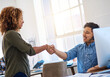 © peopleimages.com - Business people, promotion and handshake with greeting, office and congrats with call center. Telemarketing, coworkers and employees shaking hands, computer and agreement with support and cooperation