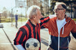 © Davor - Two active senior men hugging after soccer game in the park