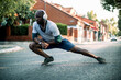 © Geber86 - Active young black man stretching on the street