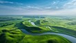 Expansive aerial landscape of rolling green hills,winding rivers,and wispy cloud-filled blue skies in the American heartland