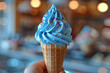 Hand Holding Blue Ice Cream Cone With Sprinkles,
Ice cream cone on a blue background

