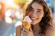 Young beautiful woman eating ice cream in waffle cone