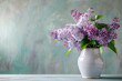 Lilac flowers in the vase on the table