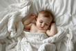 cute baby sleeping under white cotton blanket with copy space
