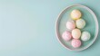 A top view of an assortment of colorful mochi beautifully arranged in a teal plate, ideal for use in festive season promotions or as a vibrant addition to a dessert cookbook.