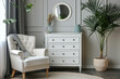 © Alina - White chest of drawers and armchair in stylish living room interior