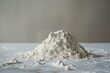 A pile of flour on a white surface.