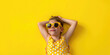 © Karat - Photo of a kid  wearing yellow sunglasses and a sundress