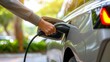© YURY YUTY - Electric Vehicle Charging at a Station