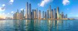 © Ľudovt - Wide panorama of a bustling modern city skyline with towering skyscrapers and water reflections.