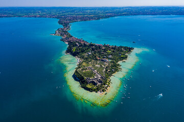 Wall Mural - Aerial View of Sirmione Peninsula on Lake Garda, Italy, Showcasing Turquoise Waters and Vibrant Lakeside Town