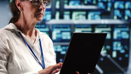 Poster - senior technician in server room equipped to handle modern computing requirements, doing regular upg