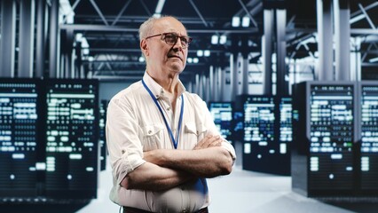 Poster - portrait of elderly engineer looking around modern server room in data center, preparing to start co