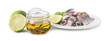 Tasty fish marinade in jar, herring and lime isolated on white