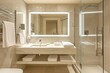 © Zidane - bathroom with marble sink and matching marble floors and walls with shower and frameless wall mirror, towel racks with clean towels and chrome fixtures, shower